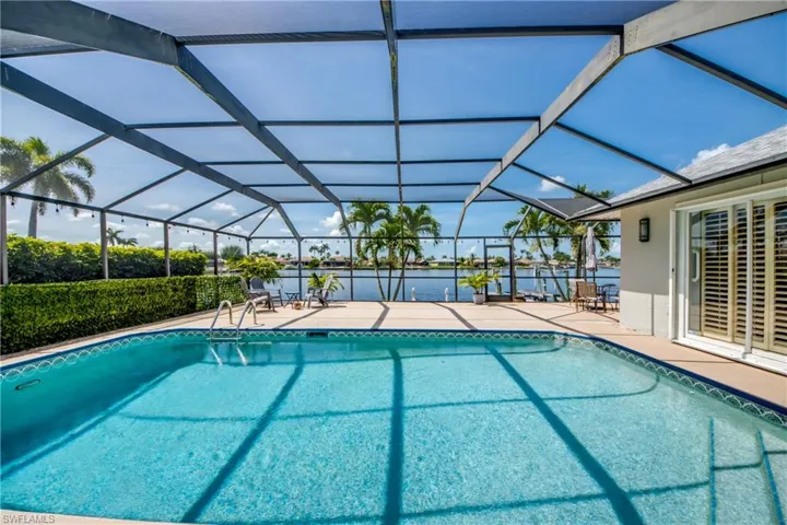 Swimming pool featuring a patio area and a lanai