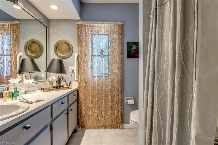 Full bath featuring double vanity and tile patterned floors