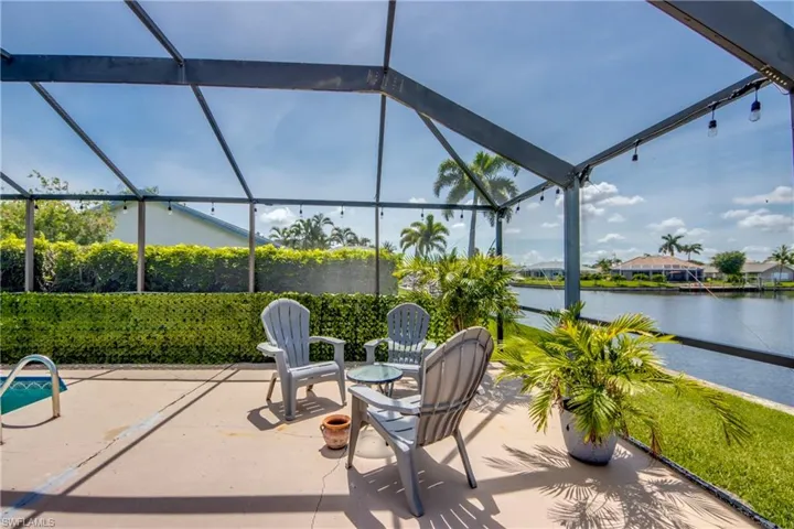 View of patio with a lanai and a water view