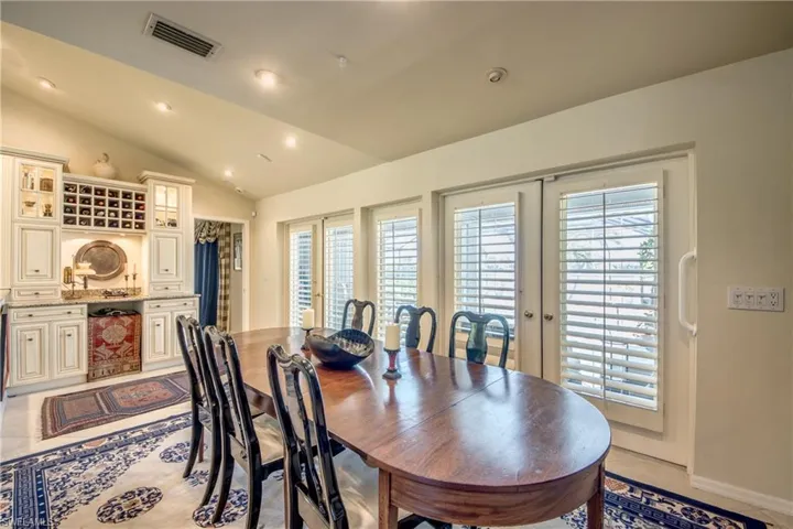 Dining space featuring vaulted ceiling, french doors, and recessed lighting