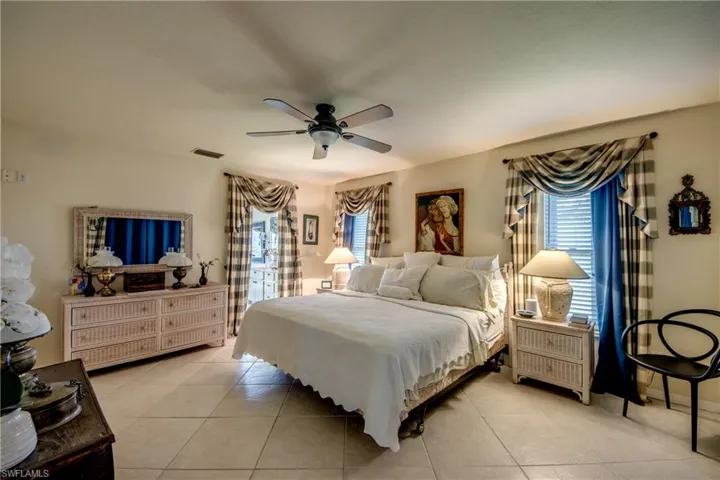 Bedroom featuring light tile patterned floors and ceiling fan