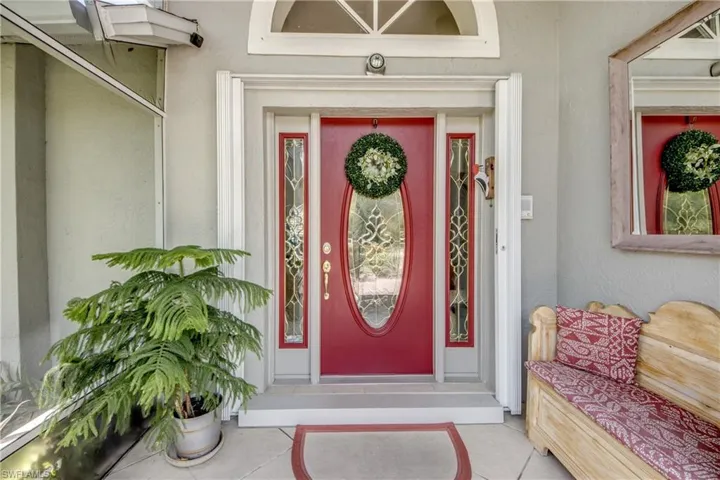 Entrance to property with stucco siding