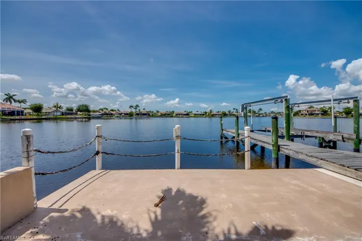 Dock area with boat lift and a water view