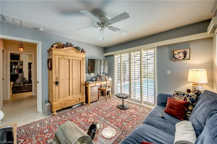 Living room featuring a ceiling fan and light tile patterned flooring