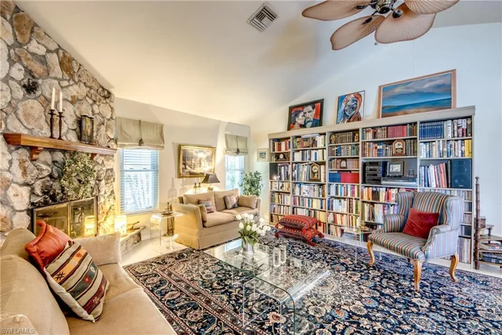 Living area featuring ceiling fan and lofted ceiling