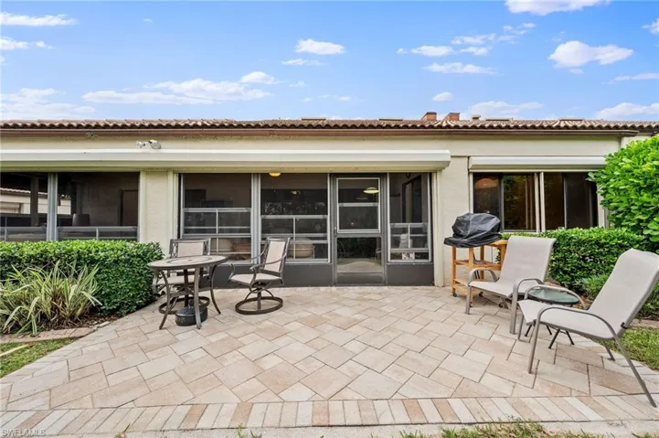 View of patio featuring a sunroom and area for grilling