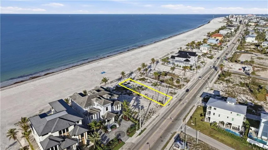 Aerial view of residential area featuring expansive beach - Virtually Edited Image