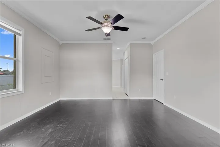 Spare room with a ceiling fan, ornamental molding, wood finished floors, and recessed lighting