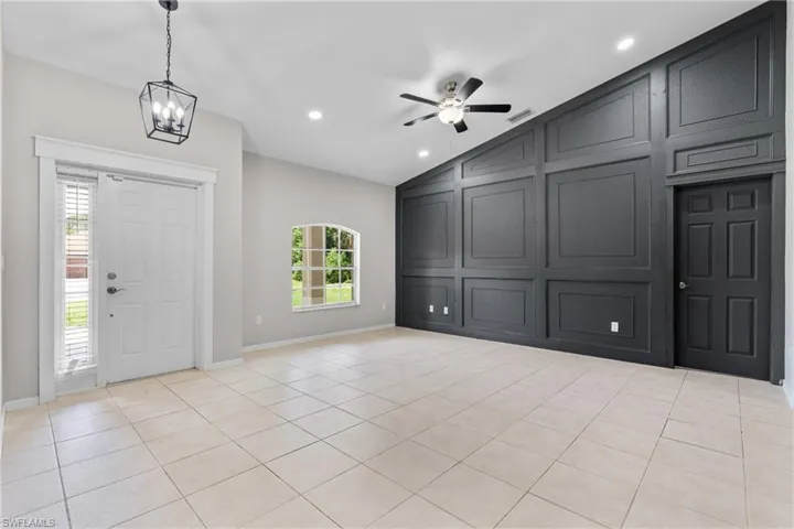 Entrance foyer featuring lofted ceiling, ceiling fan, recessed lighting, a chandelier, and light tile patterned floors