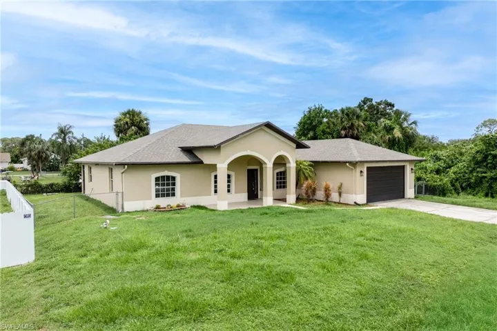 Ranch-style home with a garage, concrete driveway, and stucco siding