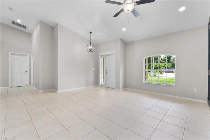 Spare room with a ceiling fan, light tile patterned floors, lofted ceiling, and recessed lighting