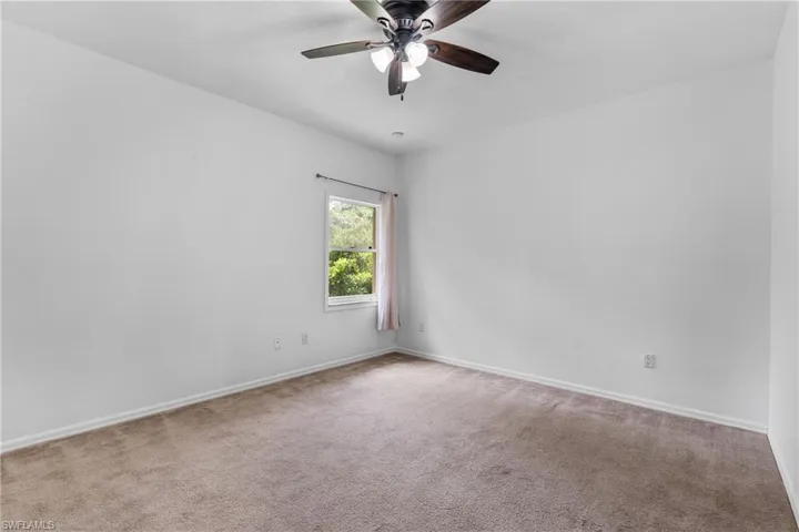 Unfurnished room with carpet and ceiling fan
