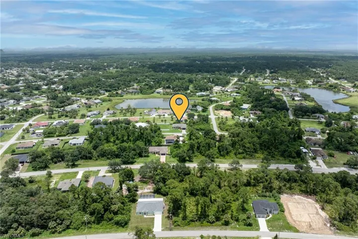 Aerial overview of property's location with a nearby body of water