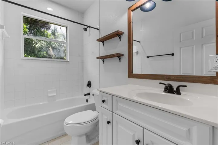 Bathroom featuring vanity and shower / tub combination