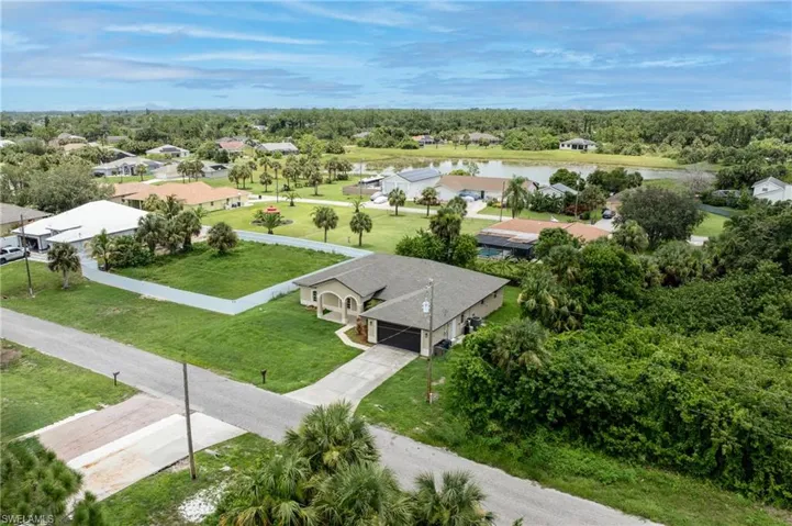Aerial view of residential area featuring a large body of water