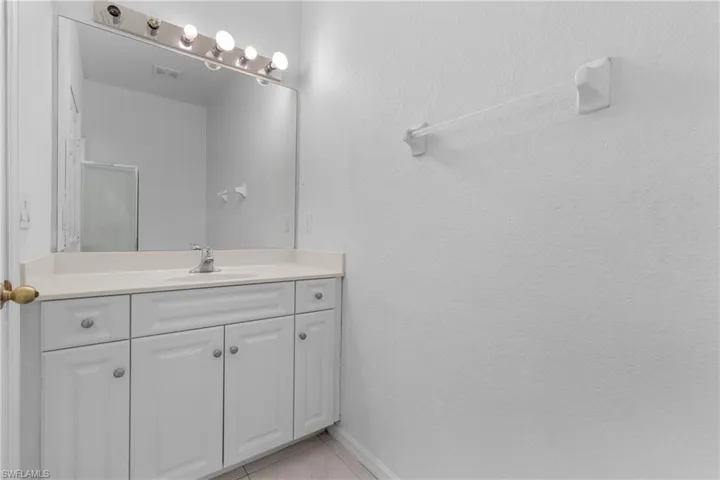 Bathroom with vanity and tile patterned flooring