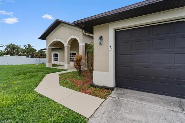 View of exterior entry featuring stucco siding