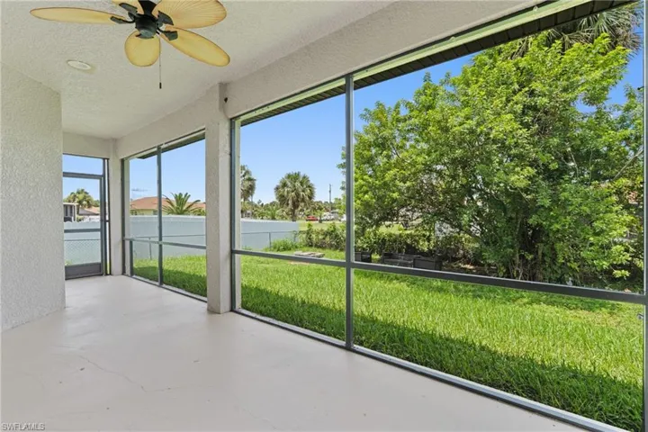 Unfurnished sunroom featuring ceiling fan