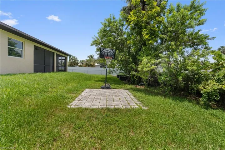 View of yard featuring a sunroom and a patio area