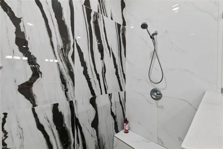 Bathroom with a marble finish shower