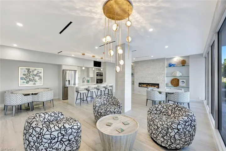 Living room featuring a fireplace, a chandelier, built in shelves, and recessed lighting