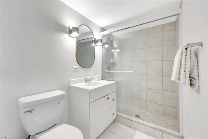 Full bathroom featuring vanity and a shower stall
