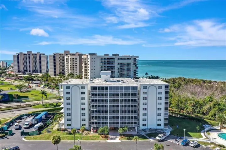 Bird's eye view of apartment complex and a large body of water