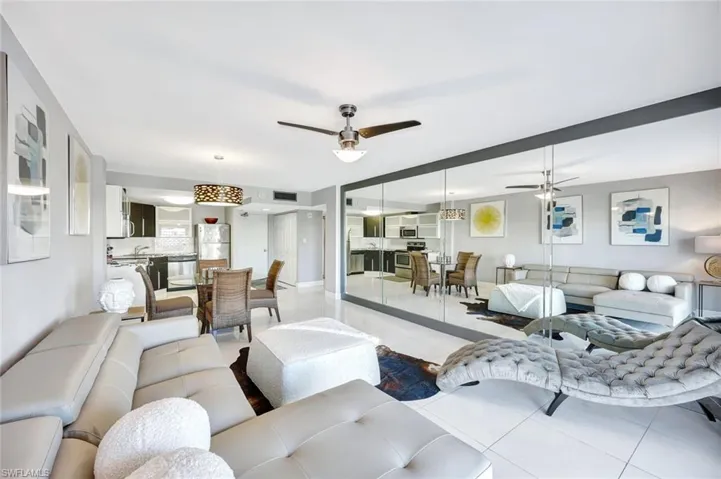 Living area with ceiling fan and tile patterned floors