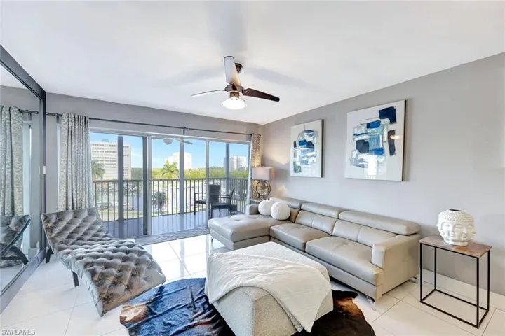 Tiled living room featuring ceiling fan