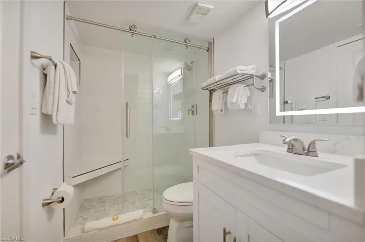 Full bath featuring vanity and a shower stall