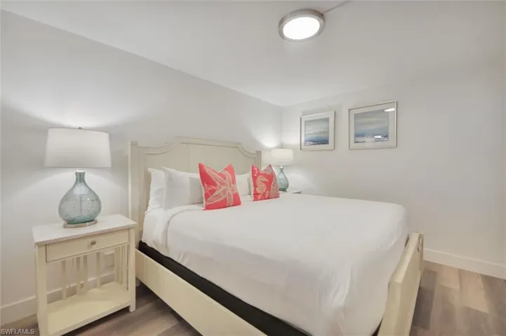 Bedroom featuring baseboards and wood finished floors