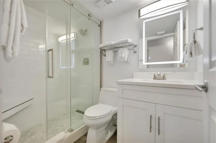 Bathroom featuring vanity and a stall shower