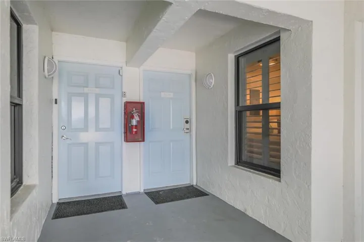Doorway to property with stucco siding