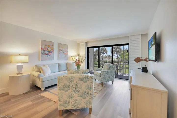 Living area with light wood finished floors and baseboards