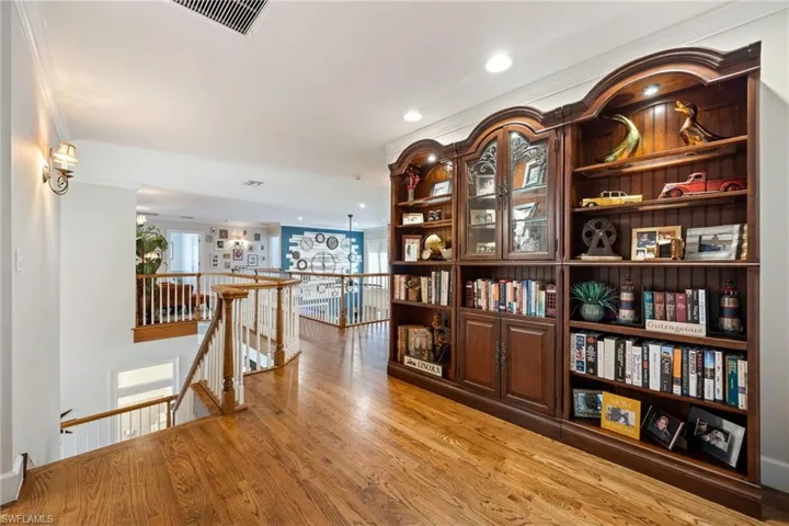 Hallway featuring visible vents, an upstairs landing, recessed lighting, and light wood finished floors