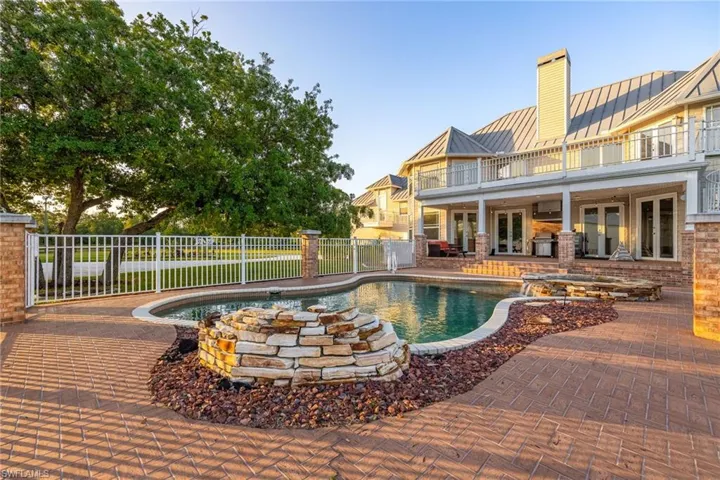 View of swimming pool featuring a patio, french doors, a fenced in pool, and fence