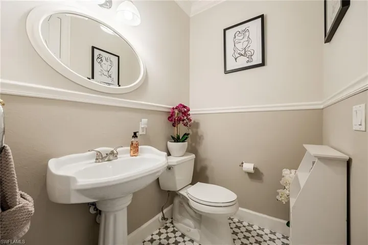 Half bathroom featuring toilet and baseboards
