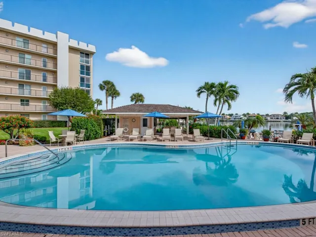 Venetian Cove Club Pool with Club room. Beautiful landscaping, plenty of pool side lounge chairs and tables. Right on the bay to enjoy that warm breeze coming off the water.