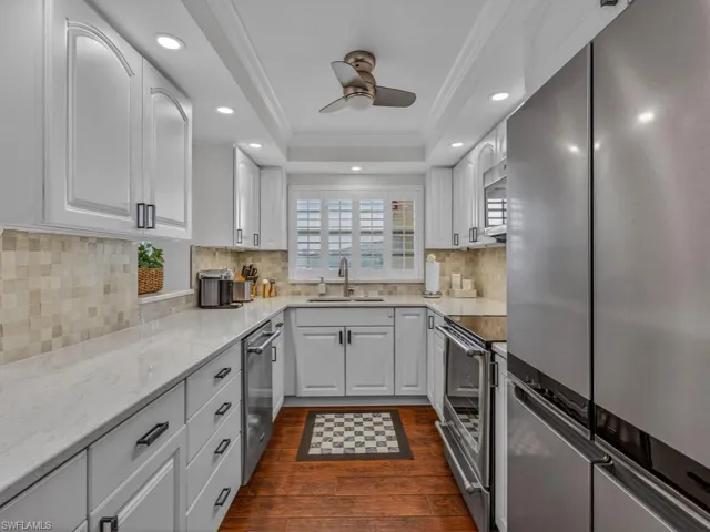 Updated Kitchen with installed pull out drawers in cabinets, recessed lighting, new stainless steel appliances and fully furnished for you to move right in.
