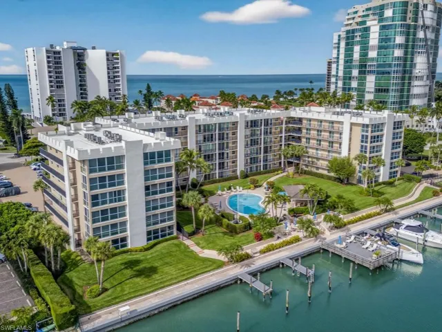 Drone / aerial view showing pool, picnic area, deck and numerous boat docks