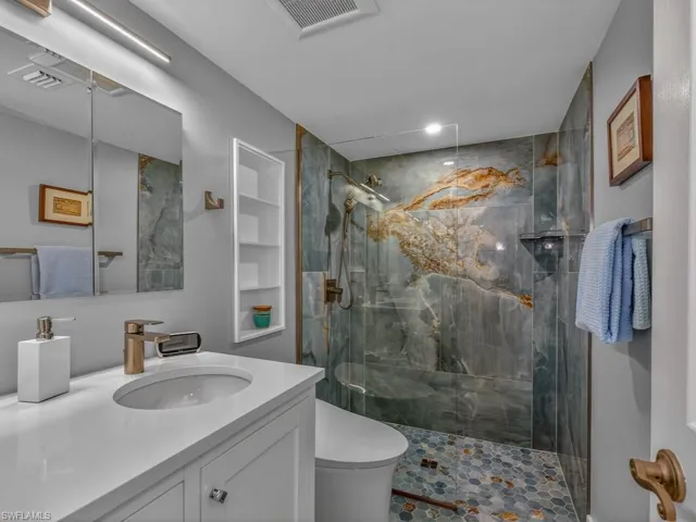 Enjoy this recently remodeled Master Bath Wet Room featuring designer tile, glass, new fixtures, doorless entry walk-in shower, and touchless controlled bidet