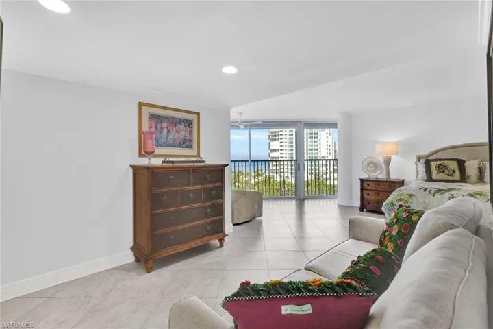 Living room with light tile patterned floors and expansive windows