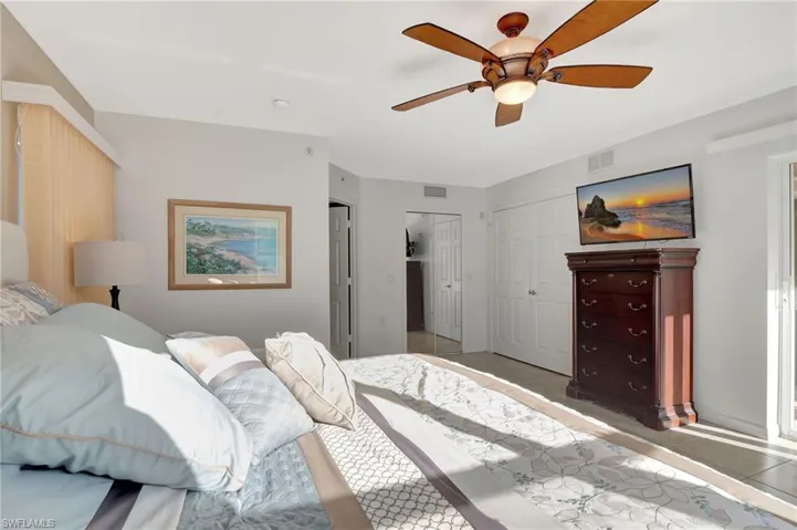 Bedroom with a ceiling fan, visible vents, and light tile patterned floors