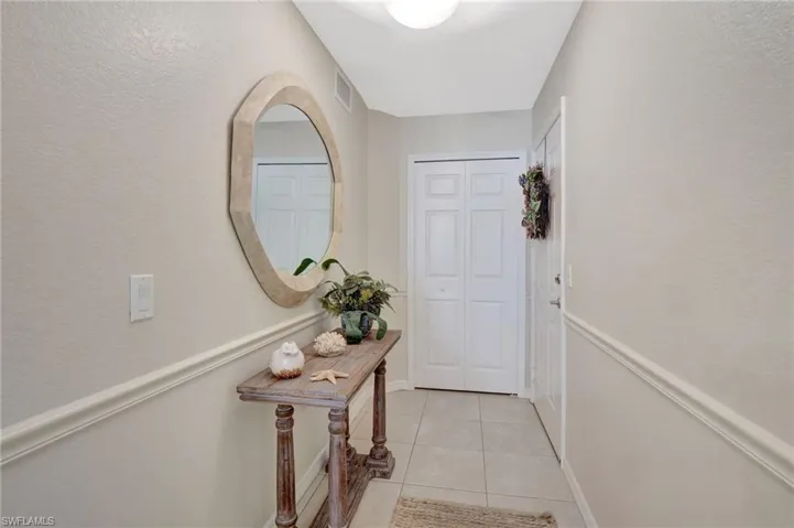Doorway to outside featuring visible vents and light tile patterned floors
