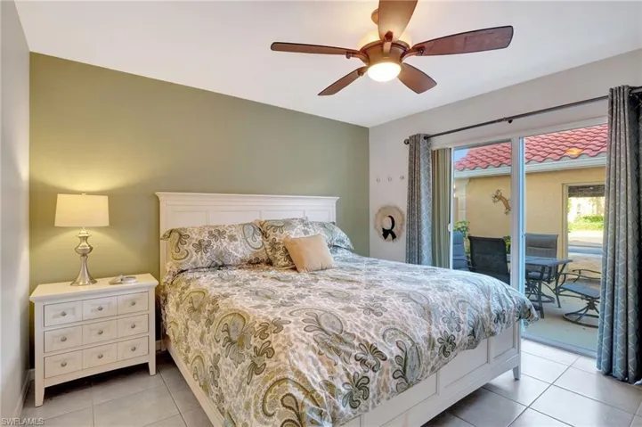 Bedroom with a ceiling fan, access to outside, and light tile patterned floors