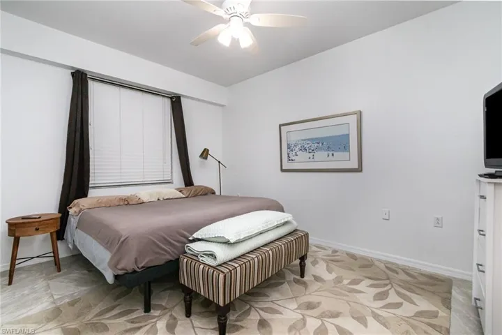 Bedroom with baseboards and ceiling fan