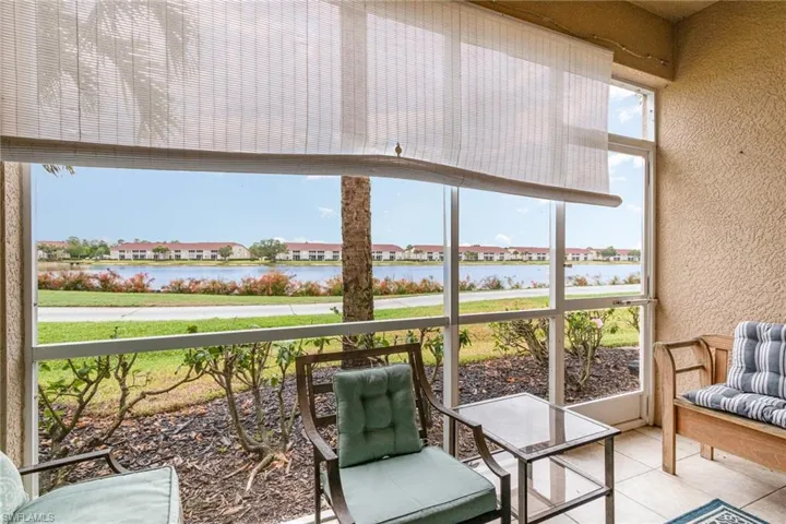 Sunroom / solarium featuring a water view and a residential view