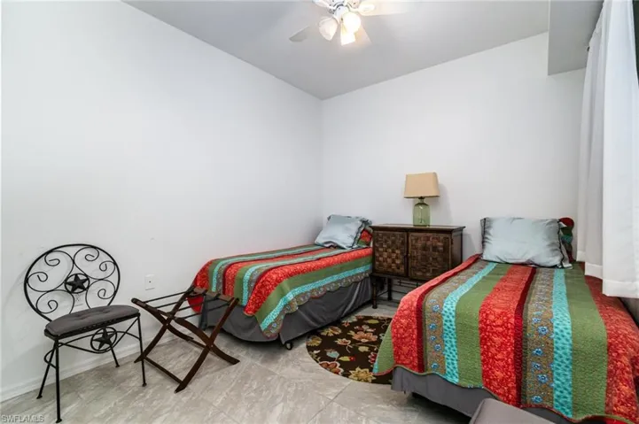 Bedroom with baseboards and a ceiling fan