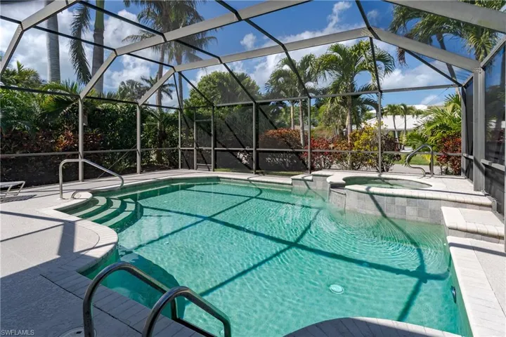 Relaxing pool / spa with a sunroom, a patio, and glass enclosure