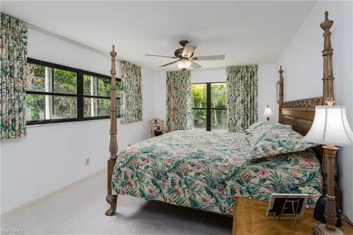 Carpeted bedroom featuring access to exterior and a ceiling fan